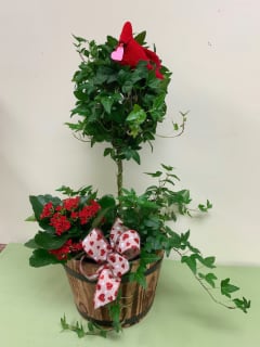 Ivy topiary plant in rustic barrel with blooming touch