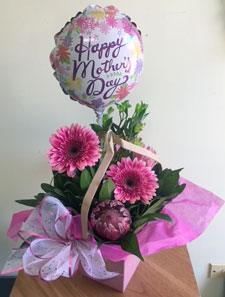 Tropical proteas with other beautiful assorted fresh flowers in gift bag with balloon