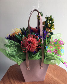 Tropical proteas with other beautiful assorted fresh flowers in gift bag with balloon