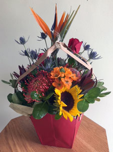 Tropical proteas with other beautiful assorted fresh flowers in gift bag with balloon